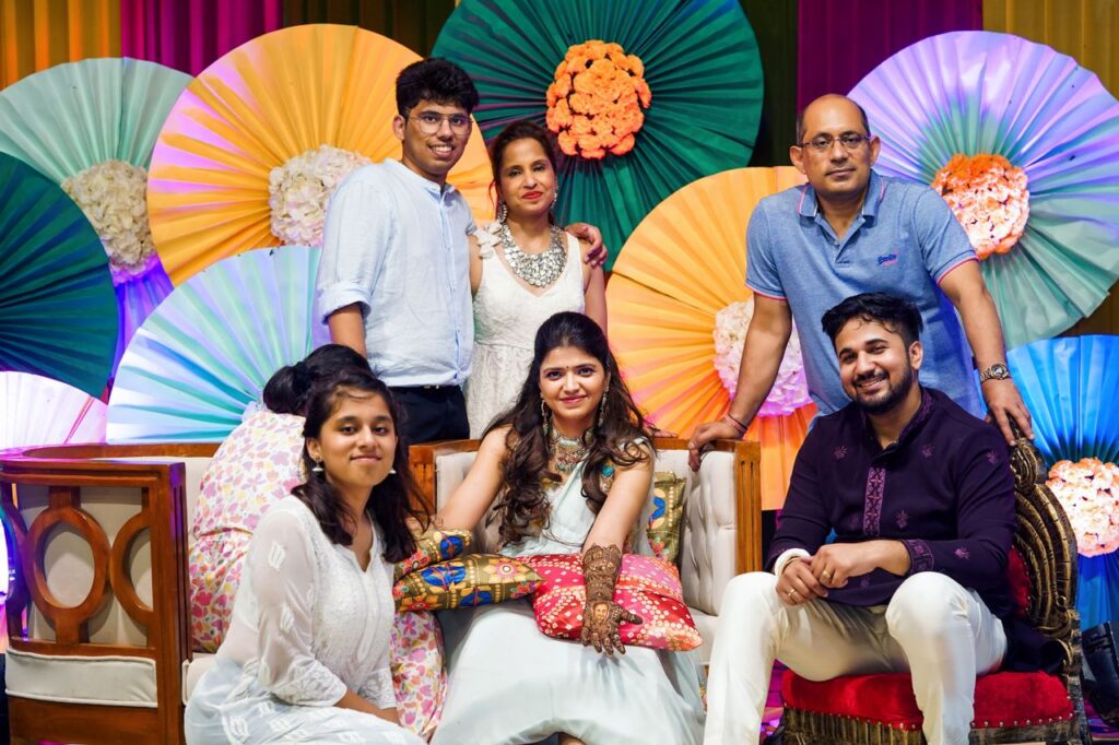 A joyful family gathering indoors with colorful decor, celebrating a special occasion with smiles and warmth.