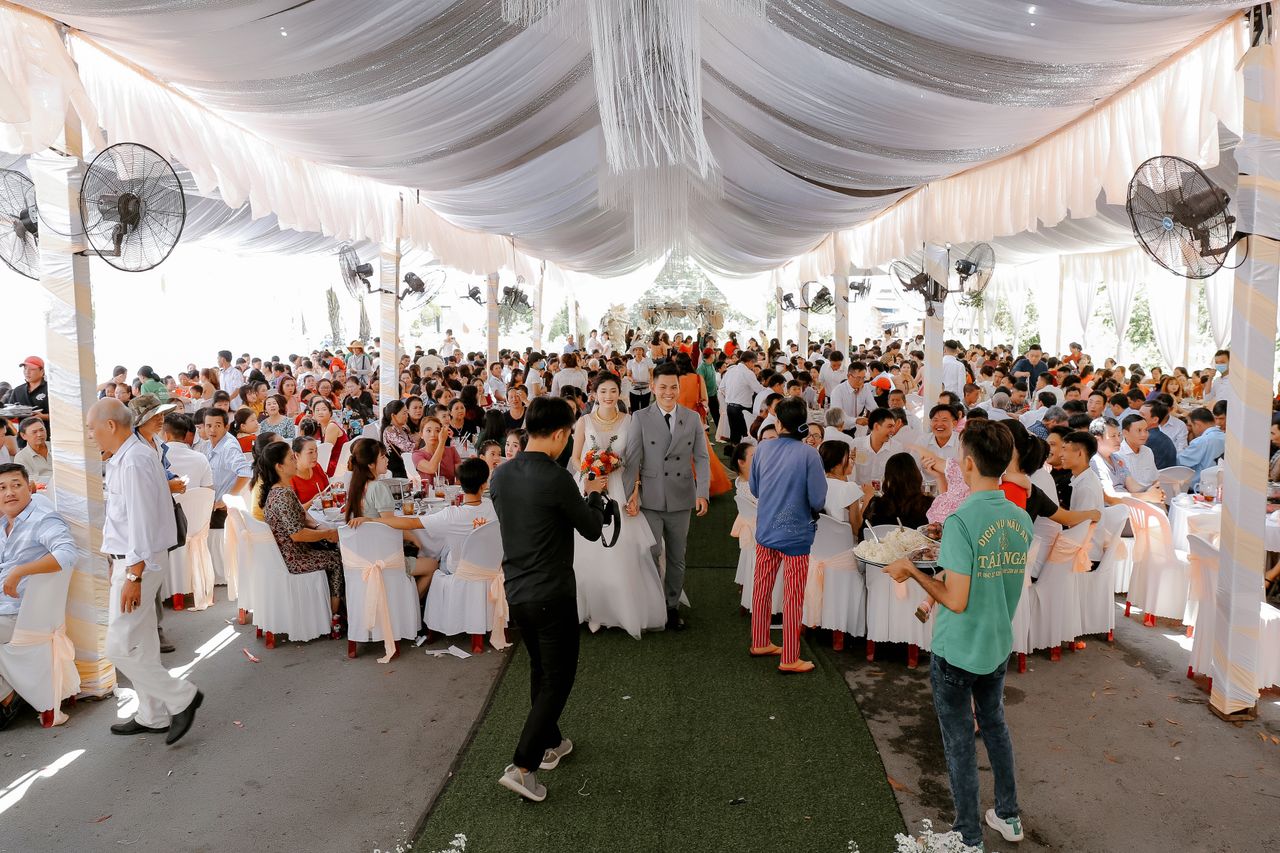 Group of people gathering together for wedding ceremony and party in decorated area